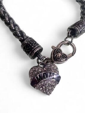 Silver heart charm bracelet with 'MOM' inscriptions.
